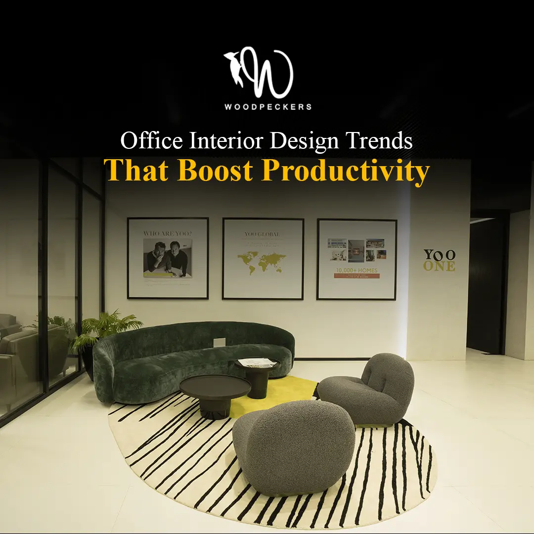 Modern office interior design featuring a collaborative lounge area with a green curved sofa, ergonomic grey chairs, and a patterned rug, showcasing productivity-boosting trends by Woodpeckers.